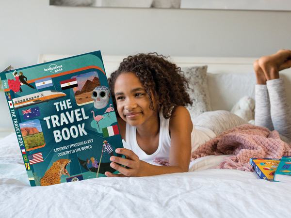 Child reading a Lonely Planet Travel book
